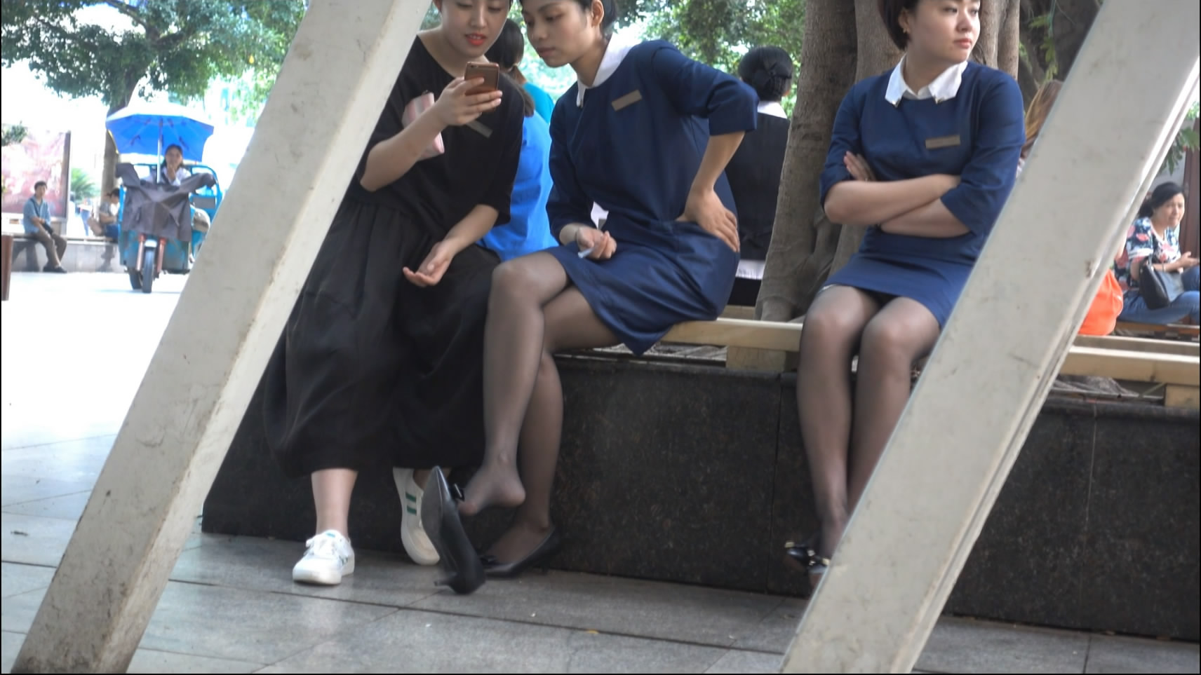 Uniformed women and dangling legs